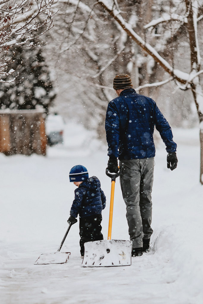 father and son shoveling snow