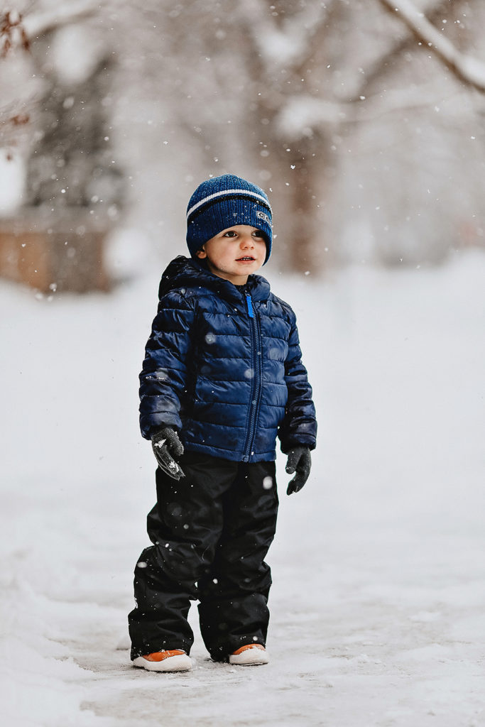 toddler standing in the snow